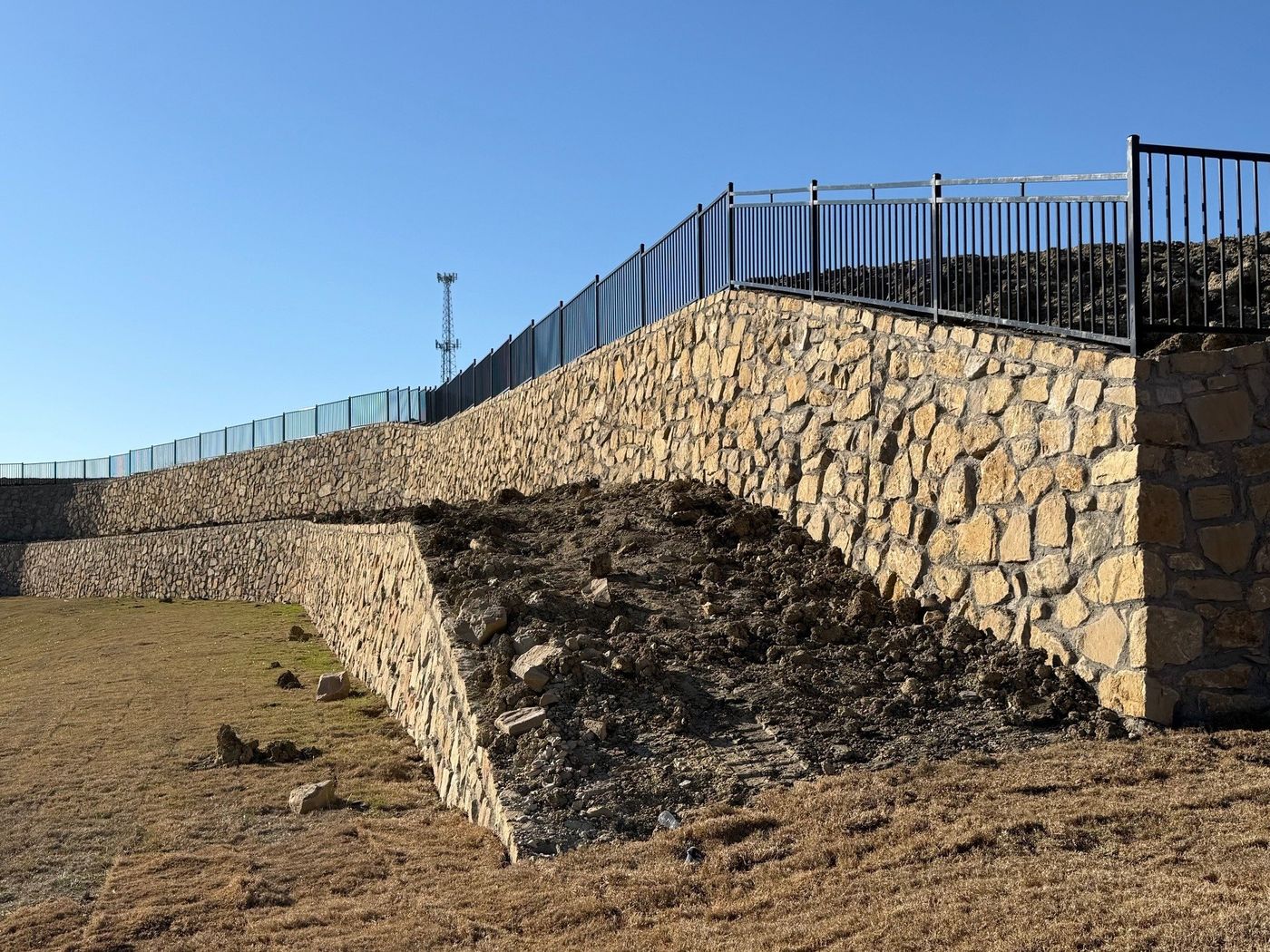 Stone wall and wing wall below a fenced lot line, Acorn North Ph 2, Princeton
