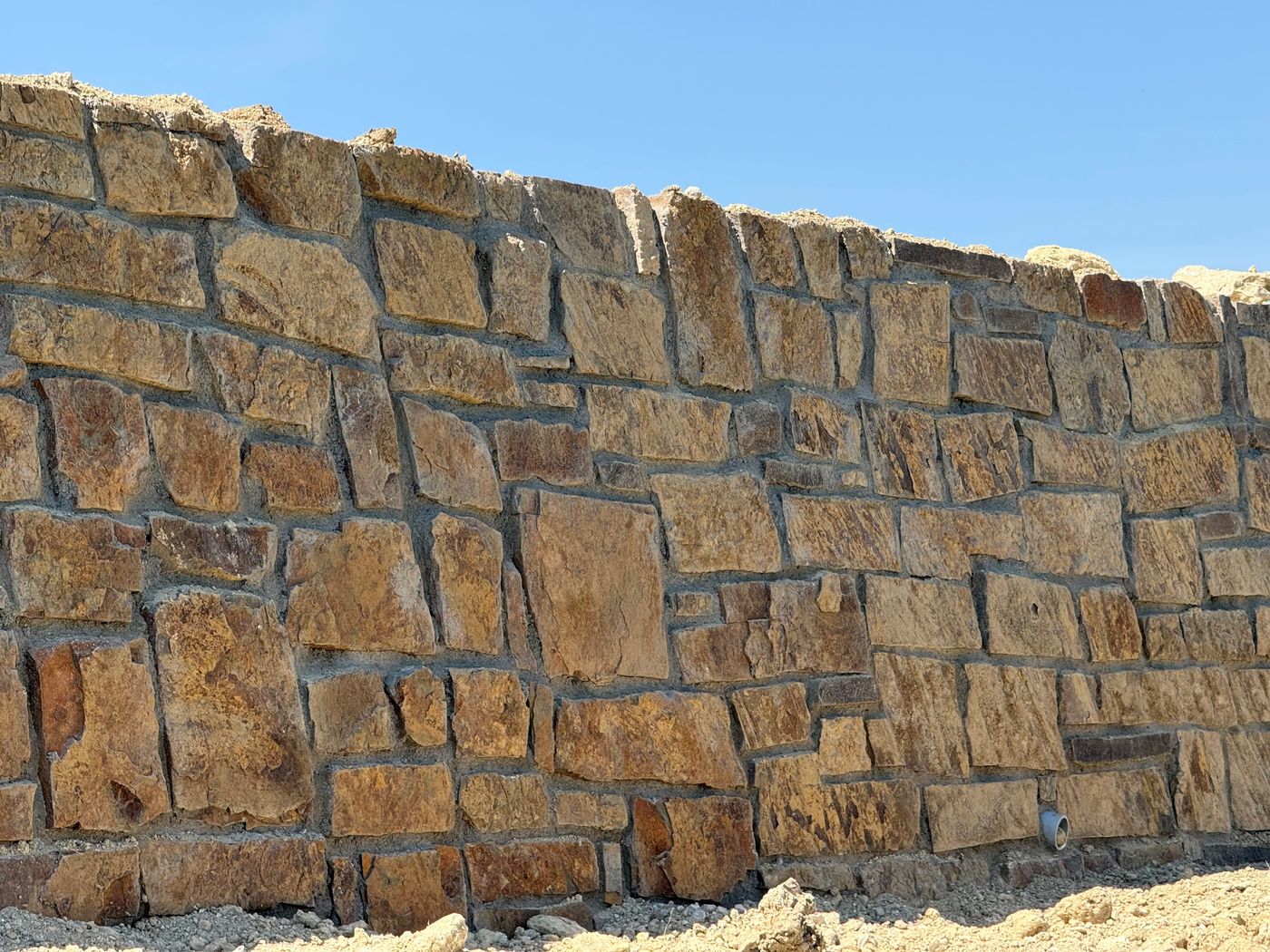 Mortared stone wall below multifamily, Alliance Town Center South, Fort Worth