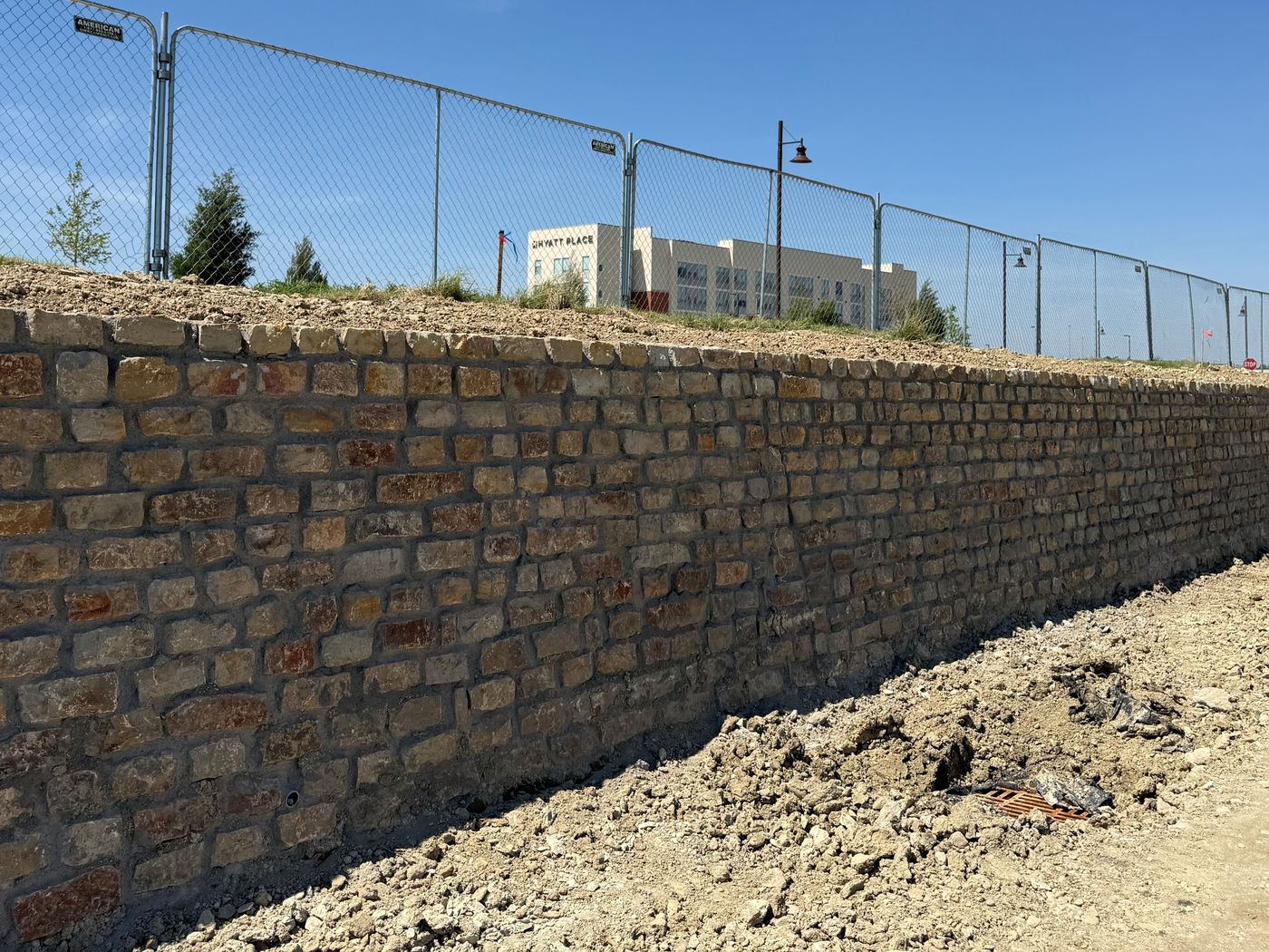 Stone wall along a fenced site, Alliance Town Center South, Fort Worth