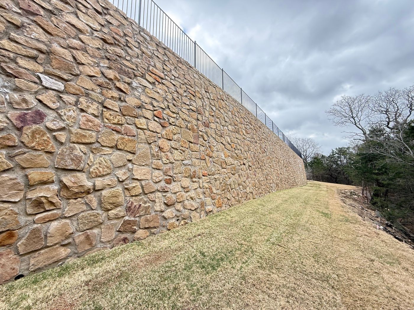 Mortared stone wall above the tree line, Lakeside at Silveron, Flower Mound