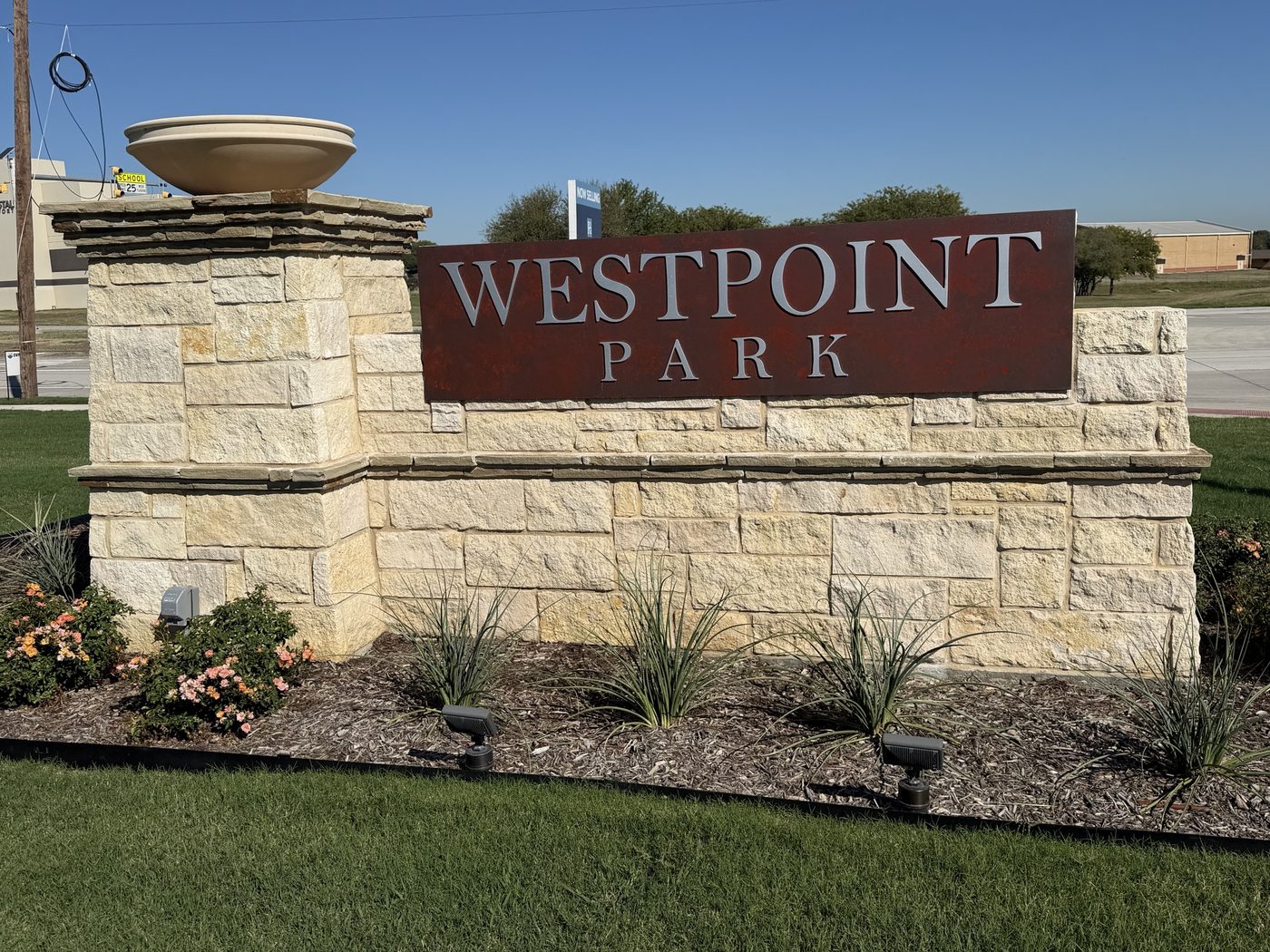 Stone entry monument with steel sign panel, Westpoint Park, Fort Worth